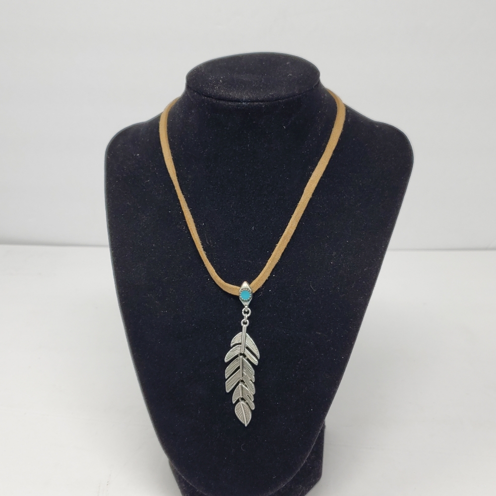 Silver tone metal feather necklace with leather cord and adjustable closure